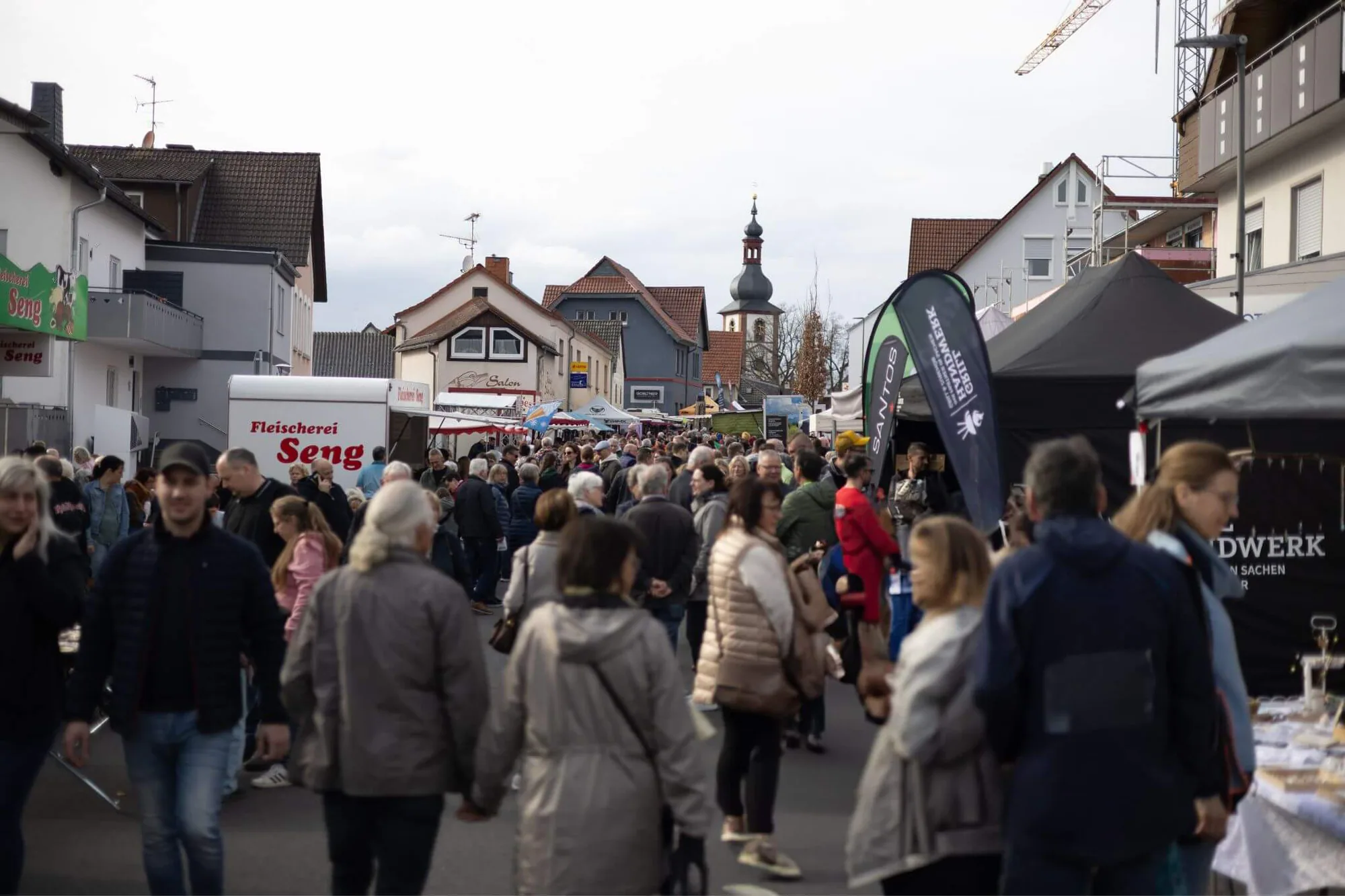 Dicht gefüllte Marktstraße mit Blick auf den Kirchturm